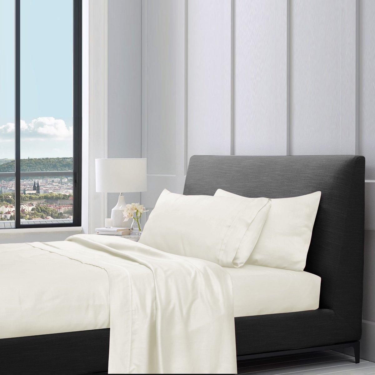1200TC pure cotton sheet set in cream styled on a bed with pillows