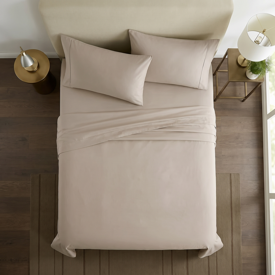 Overhead view of taupe cotton sheet set with folded top sheet and pillowcases