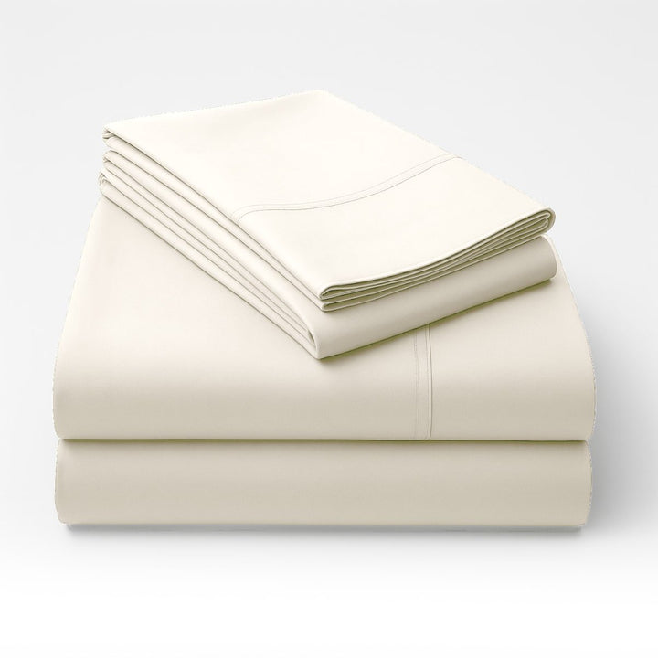 Folded cream cotton sheet set stacked showing smooth fabric finish