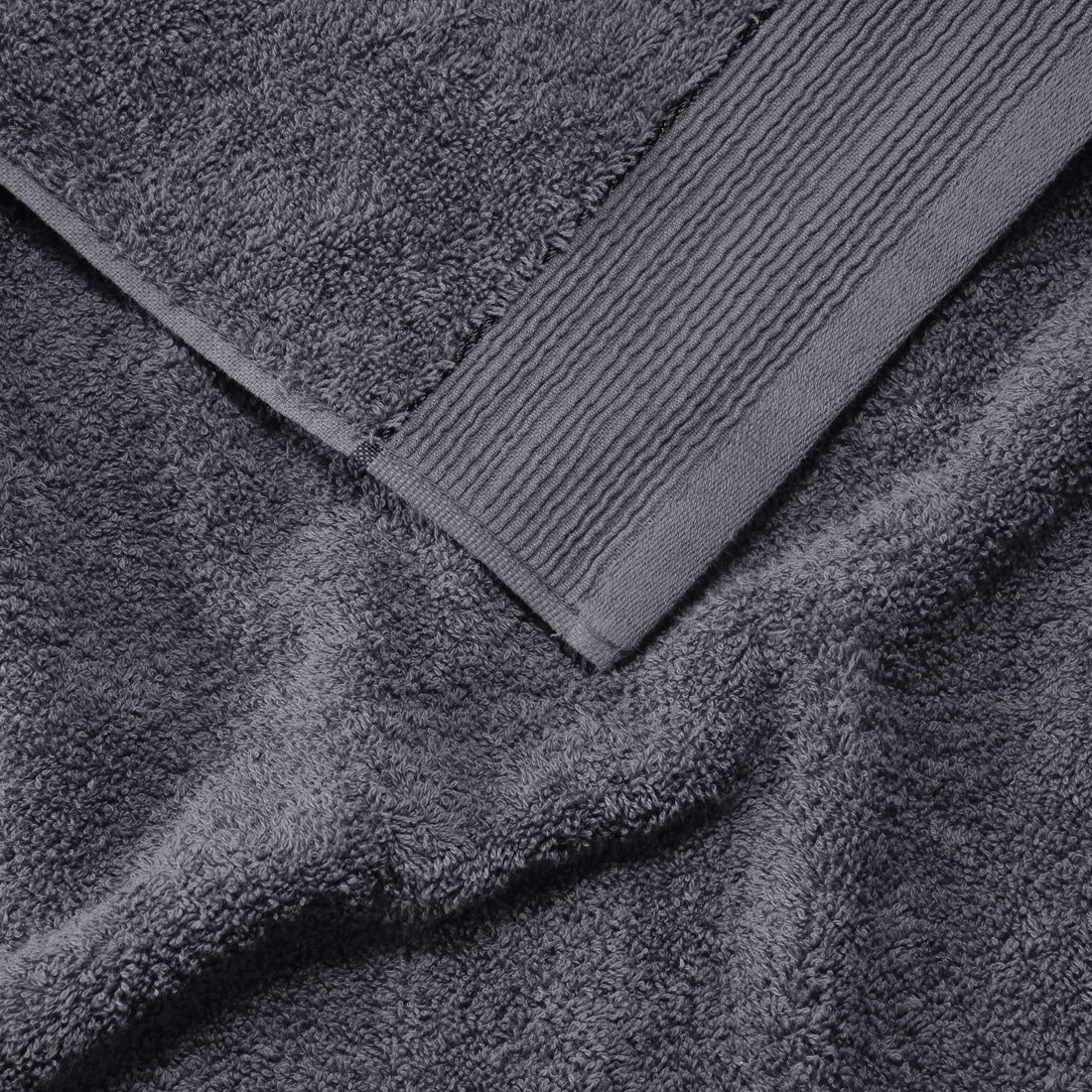 Stacked grey towels folded neatly