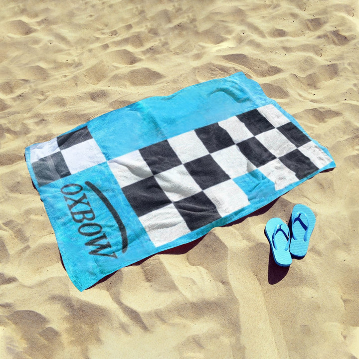 Oxbo Blue 1Oxbow blue checkered towel on sand