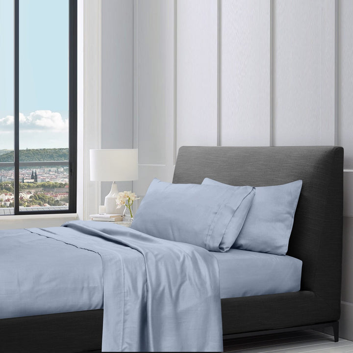 1200TC pure cotton sheet set in pale blue styled on a bed with pillow
