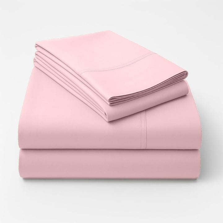 Folded pink cotton sheets stacked neatly