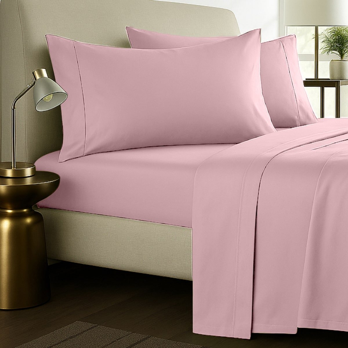 Pink bed sheets with pillows styled