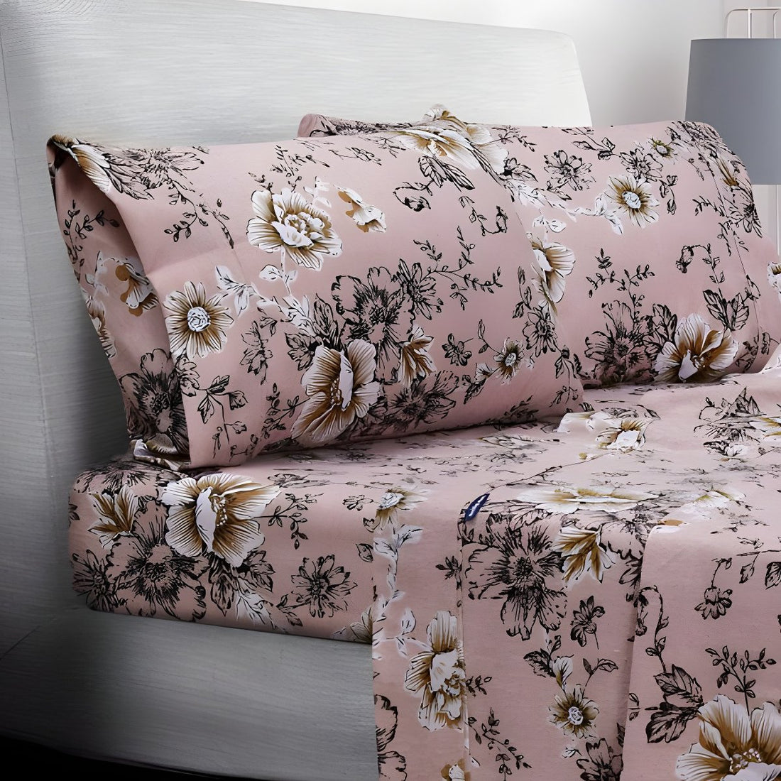 Folded pink floral sheets stacked neatly