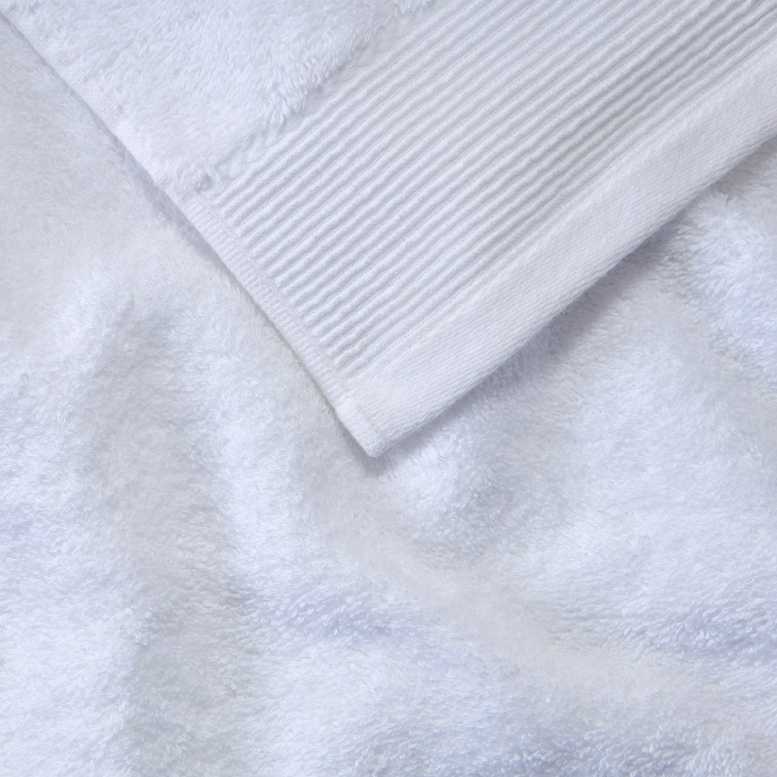 White organic cotton towels stacked neatly